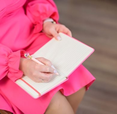 the-hand-of-a-girl-in-a-pink-dress-makes-a-note-in-2026-03-16-04-26-26-utc